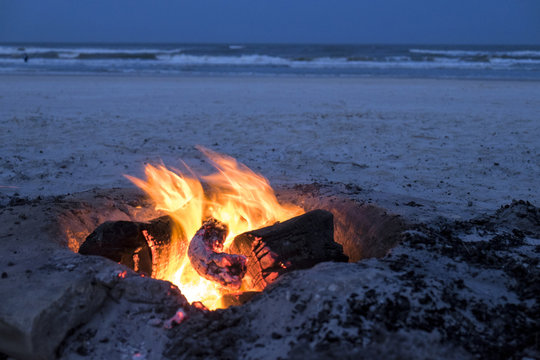 Campfire burning on the New Smyrna Beach, USA