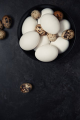Quail and chicken eggs on a table