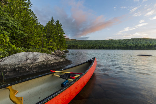 A canoe on the shore of Bald Mountain Pond at sunrise. Bald Mountain Township, Maine.