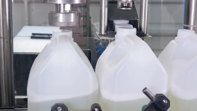 Liquid detergent on automated production line. Machinery for bottling. 4K.