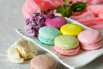 Macaroons of different flavors and a lilac branch