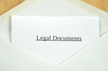 Legal Documents printed on white paper and envelope, wooden background