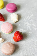 Macaroons of different tastes and strawberries, place under the text
