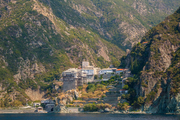 Fototapeta na wymiar View from the sea to the temple on the Holy mount Athos in Greece. The temple on mount Athos. For the travel guide. Greece