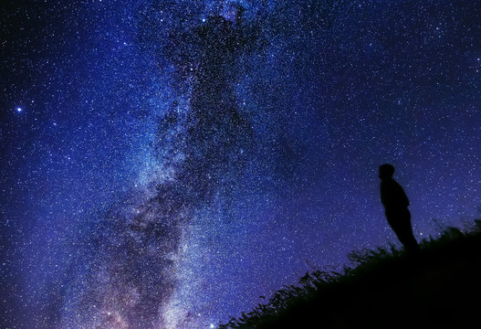 Lonely man watching the stars, different edit. Silhouette against the sky. Cygnus rift.
