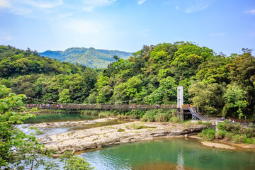 Fototapeta na wymiar Panoramic landscape near Shifen waterfall with a cable style bridge at Shifen, New Taipei City, Taiwan