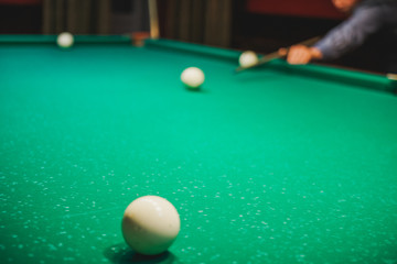 To play billiards. The man plays billiards. Desktop gambling.