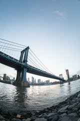 Fototapeta premium New York City's Manhattan Bridge at suset - DUMBO, Brooklyn. Shot with a fisheye lens during the spring of 2017.