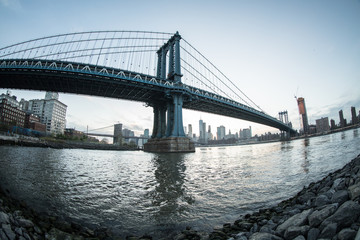 Fototapeta na wymiar New York City's Manhattan Bridge at suset - DUMBO, Brooklyn. Shot with a fisheye lens during the spring of 2017.