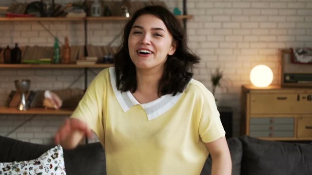 portrait young exited woman speaks emotionally and blab actively without stopping to the camera with actively gestures