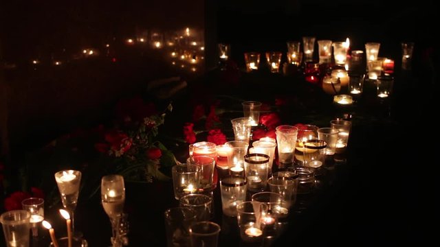 People bring candles and flowers to the scene of the terrorist attack in order to honor the memory of the dead. Politics, military actions, terrorism. People mourn