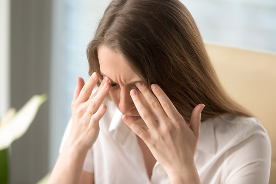 Businesswoman has painful spasm in head. Female feeling dizziness and loses consciousness. Fluctuations of blood pressure, hypertensive crisis symptoms. Headache because of critical overwork at work
