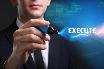 Business, Technology, Internet and network concept. Young businessman working on a virtual screen of the future and sees the inscription: Execute