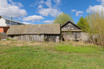 Old abandoned wooden house on a clear spring day