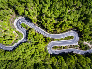 Car on winding road trough the forest, Transilvania, Romania