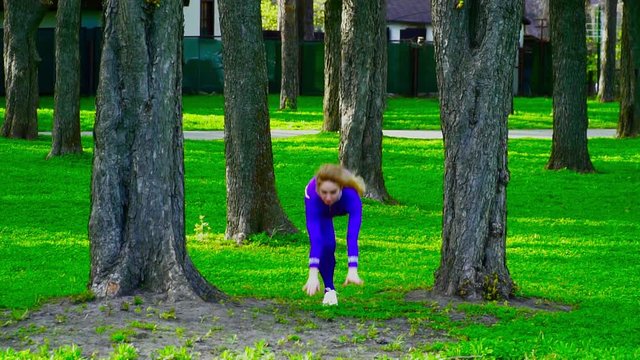 Young gymnast dacing in the park slow motion
