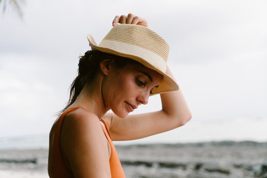 Portrait of woman in straw hat, sea background