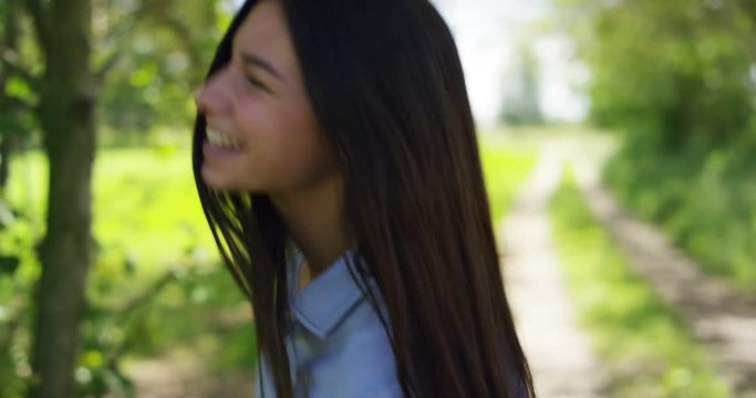 Portrait of a beautiful young girl, having fun and playing in the fresh air, in the background of nature. Concept: clean ecological air, healthy lifestyle, cleanliness, happiness and smile, fresh air.