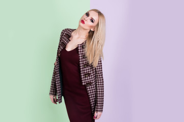 beautiful woman with makeup in dress and fashionable coat