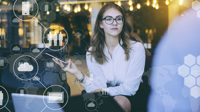 In foreground are virtual icons with clouds, people, gadgets. Business meeting. On table is laptop.