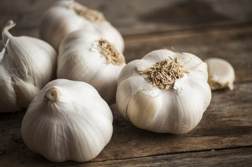 Garlic cloves on wooden vintage background.