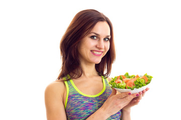 Sportive woman holding salad 