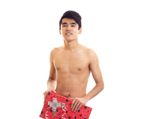 Undressed young man holding present