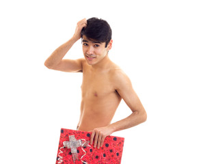 Undressed young man holding present