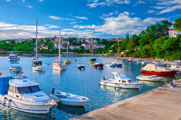 Fototapeta na wymiar Wonderful romantic summer evening landscape panorama coastline Adriatic sea. Boats and yachts in harbor at cristal clear azure water. Old town of Krk on the island of Krk. Croatia. Europe.