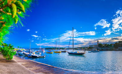 Wonderful romantic summer evening landscape panorama coastline Adriatic sea. Boats and yachts in harbor at cristal clear azure water. Old town of Krk on the island of Krk. Croatia. Europe.