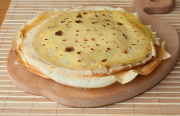 Stack of homemade pancakes on wooden board