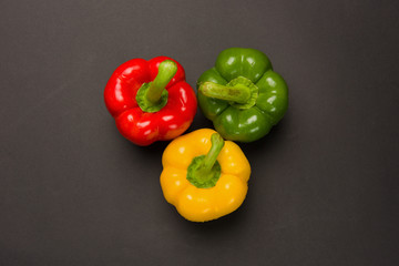 Three peppers on black background