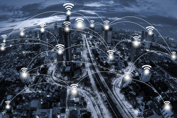 Wifi network connection concept and Network business conection system on blue tone Aerial view of cityscape Bangkok business district at twilight  background.