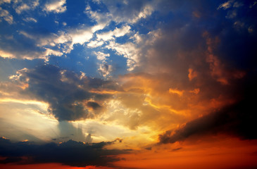 Multicolor sunset sky with clouds and sun rays