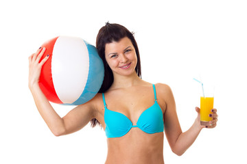 Woman in swimming suit holding cocktail and ball