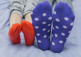 Mother and child in bright socks. Selective focus.