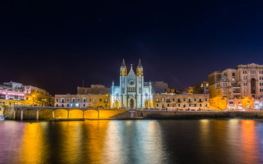 Fototapeta na wymiar Balluta bay, Malta - The beautiful Church of Our Lady of Mount Carmel at Balluta bay by night