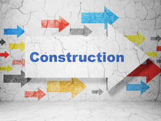 Construction concept: arrow with Construction on grunge wall background
