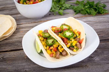 beef corn soft taco on rustic wood table