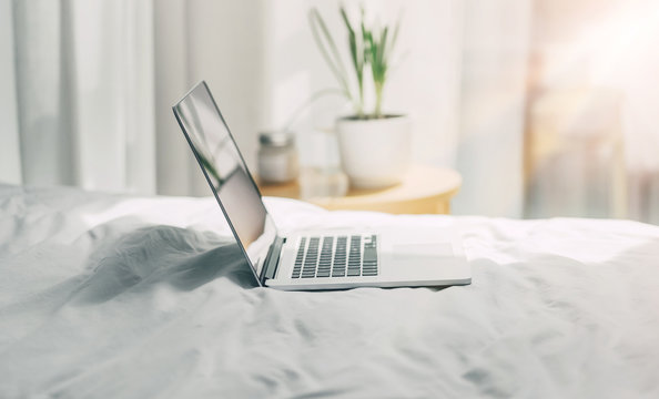 Blogger workplace early in the morning, Laptop on the bed