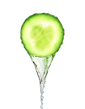 Essence flows as stream from fresh slice of cucumber on white background
