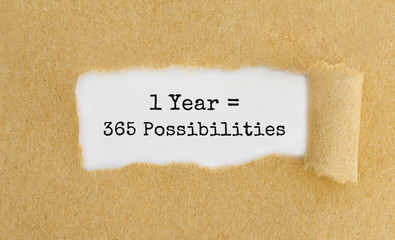 Text 1 Year 365 Possibilities appearing behind ripped brown paper
