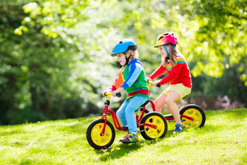 Fototapeta premium Kids ride balance bike in park