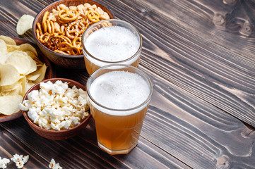 Beer with pretzels, saltsticks and potato chips. Viewed from above.