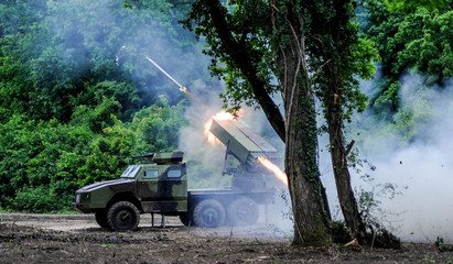 Multiple rocket launcher firing action