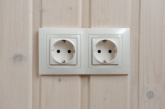 Two electrical sockets paired on the wall