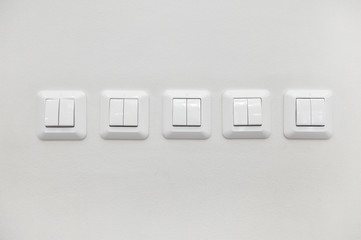 Many light switches on the wall