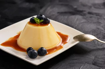 Fotobehang Cream pudding with caramel sauce and blueberries. © O.B.