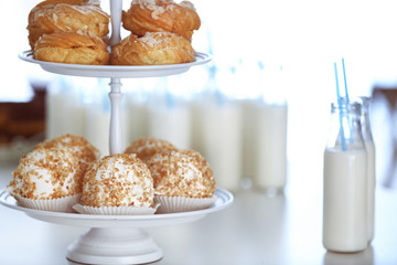 Table with bottles of milk and dessert stand