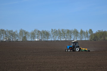 Tractor plows the land in the field